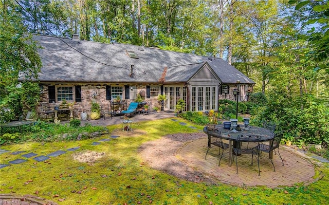 back of house with french doors, a lawn, and a patio area