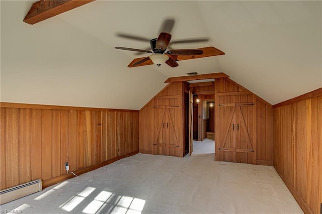 bonus room with light carpet, baseboard heating, wooden walls, and lofted ceiling