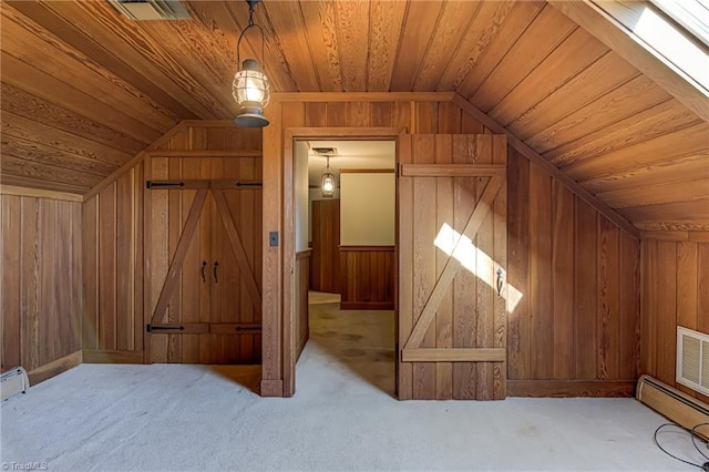 additional living space with a baseboard radiator, lofted ceiling, wood walls, and wood ceiling