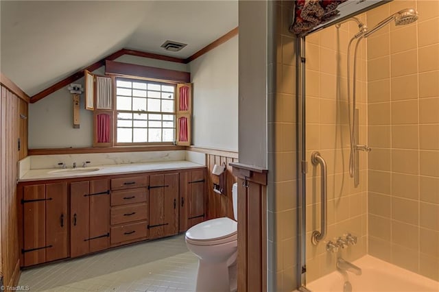 bathroom with toilet, lofted ceiling, tile patterned flooring, and vanity