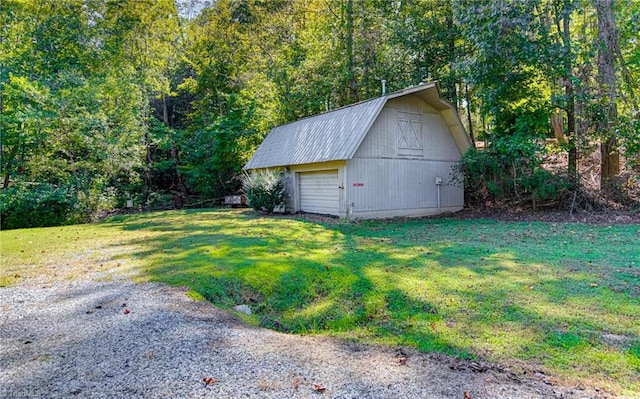 view of outbuilding featuring a lawn and a garage