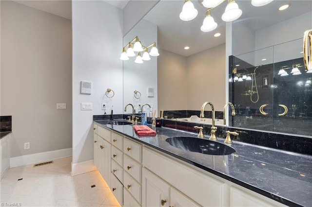 bathroom featuring tile patterned flooring, vanity, and a shower with shower door