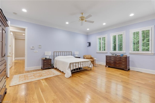 bedroom with ceiling fan, ornamental molding, and multiple windows