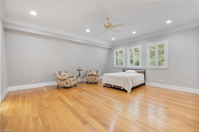 bedroom featuring light hardwood / wood-style flooring, ceiling fan, and crown molding