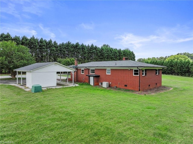 back of house featuring a lawn and a carport