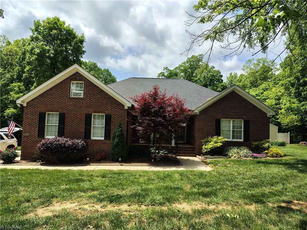 ranch-style house featuring brick siding and a front yard