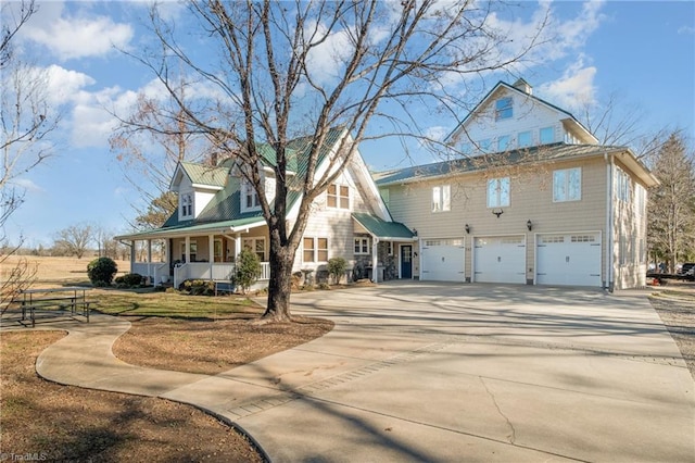 view of front facade with covered porch and a garage