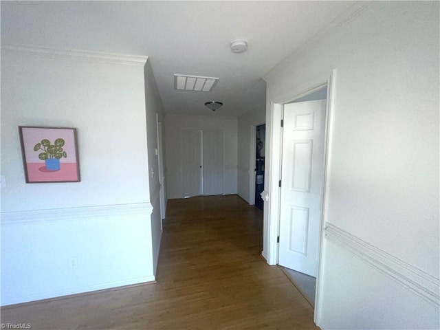 corridor featuring ornamental molding, wood finished floors, and visible vents