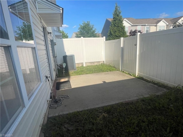 view of yard with a patio, cooling unit, and a fenced backyard