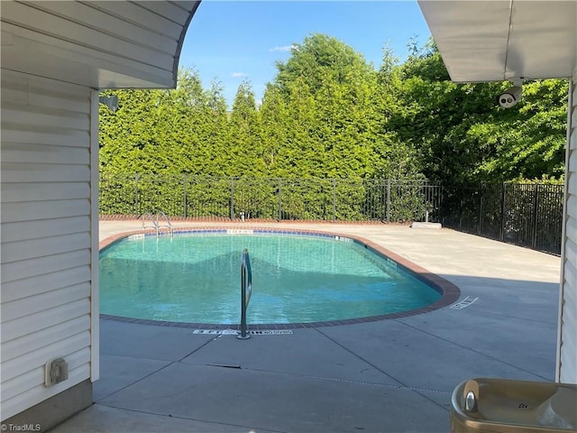 view of swimming pool featuring a patio, a fenced in pool, and a fenced backyard