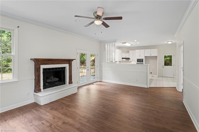 unfurnished living room with plenty of natural light and dark hardwood / wood-style floors