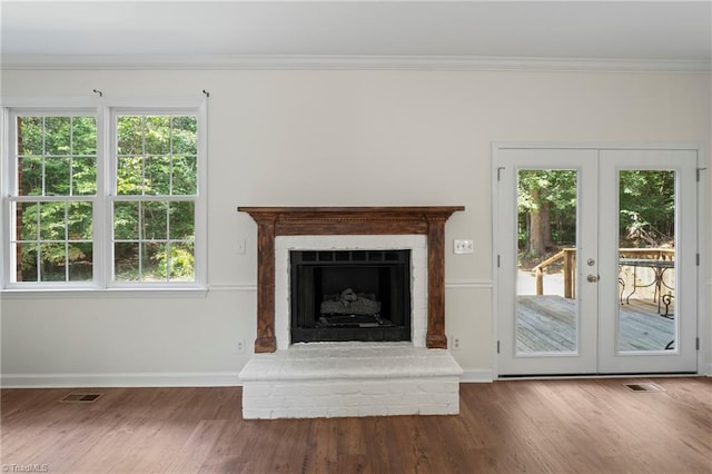 unfurnished living room with french doors, dark wood-type flooring, and a wealth of natural light