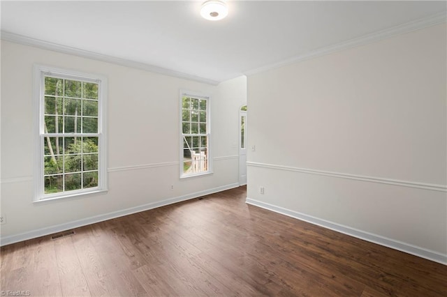 unfurnished room with ornamental molding and dark hardwood / wood-style flooring