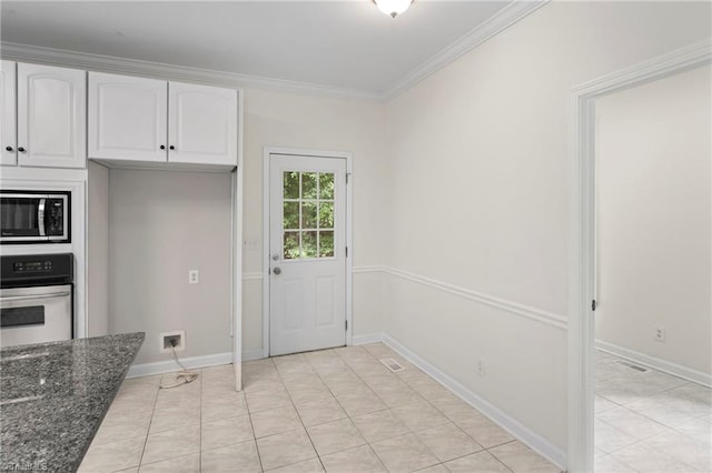 kitchen with oven, white cabinetry, dark stone counters, and ornamental molding