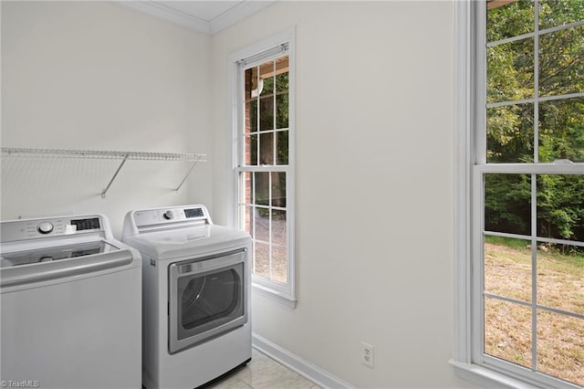 washroom with washer and clothes dryer and light tile patterned flooring