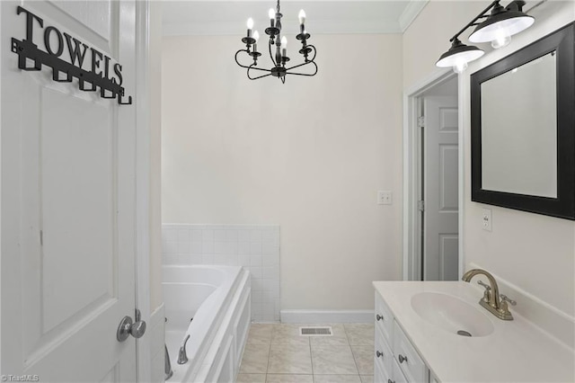 bathroom featuring a washtub, tile patterned floors, vanity, crown molding, and an inviting chandelier