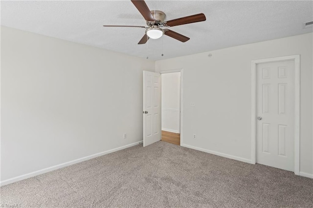 unfurnished bedroom featuring a textured ceiling, carpet, and ceiling fan