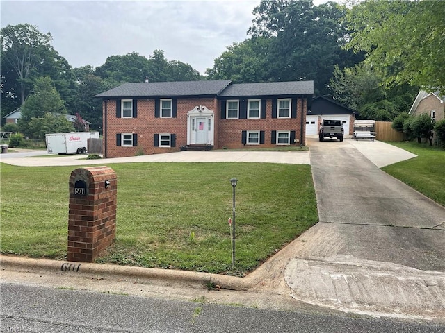 split foyer home featuring a garage and a front yard