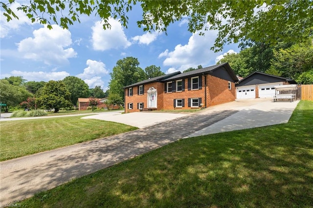 view of front of house featuring a garage, an outdoor structure, and a front yard