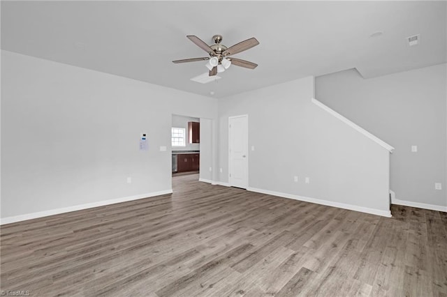 unfurnished living room featuring hardwood / wood-style floors and ceiling fan