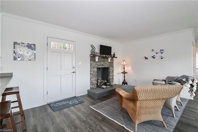 living room with dark hardwood / wood-style flooring and ornamental molding