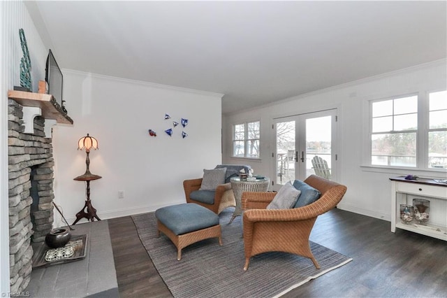 sitting room with a fireplace, crown molding, dark hardwood / wood-style flooring, and french doors