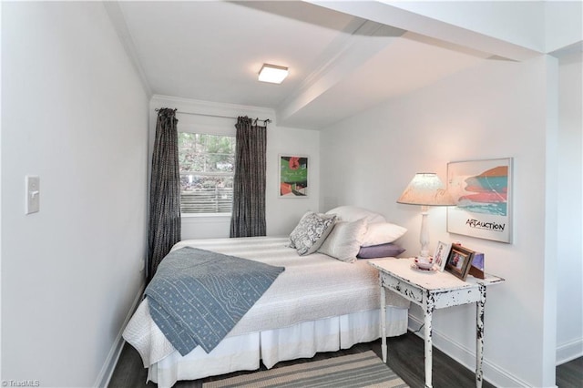 bedroom with dark hardwood / wood-style floors and ornamental molding