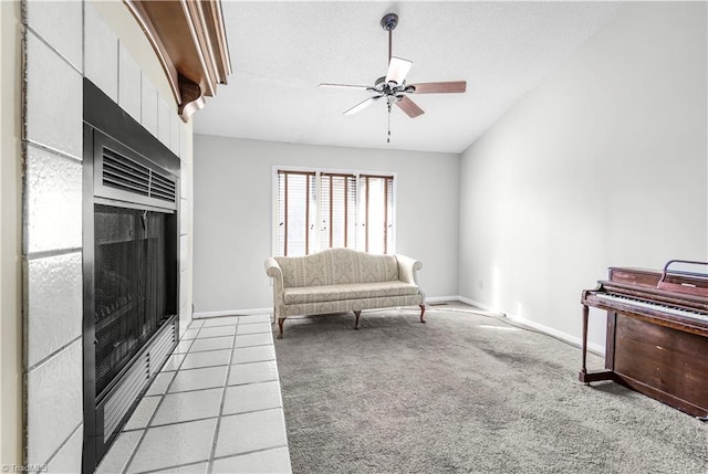 sitting room with lofted ceiling, light carpet, and ceiling fan