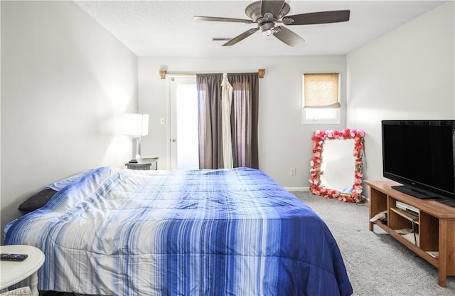 bedroom with carpet flooring, a textured ceiling, and ceiling fan