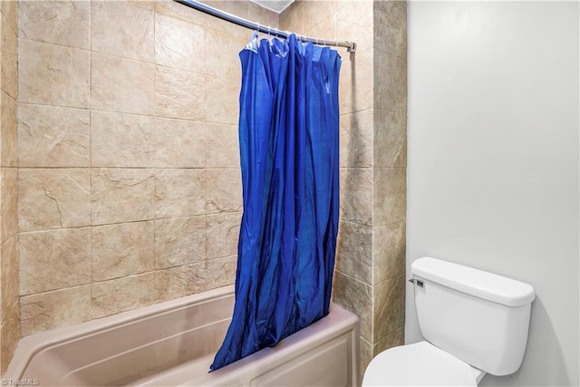 bathroom with shower / bath combination with curtain and toilet