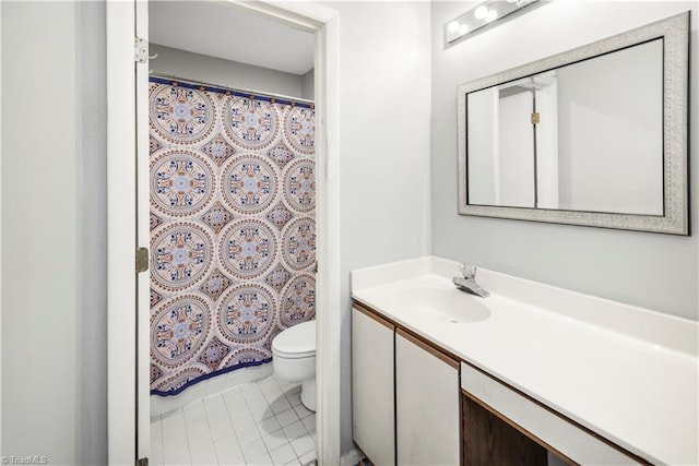 bathroom featuring tile patterned flooring, vanity, and toilet