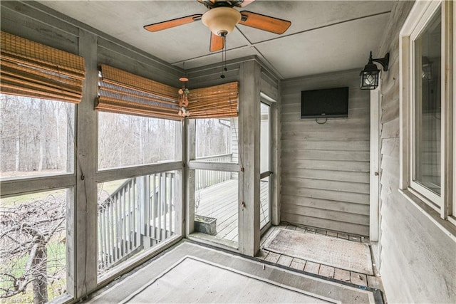 unfurnished sunroom with plenty of natural light and ceiling fan