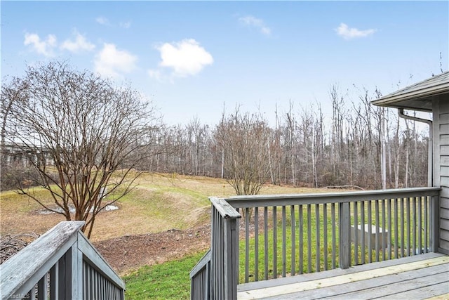 wooden terrace featuring a yard