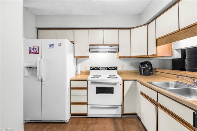 kitchen with sink, white cabinetry, wood-type flooring, a textured ceiling, and white appliances