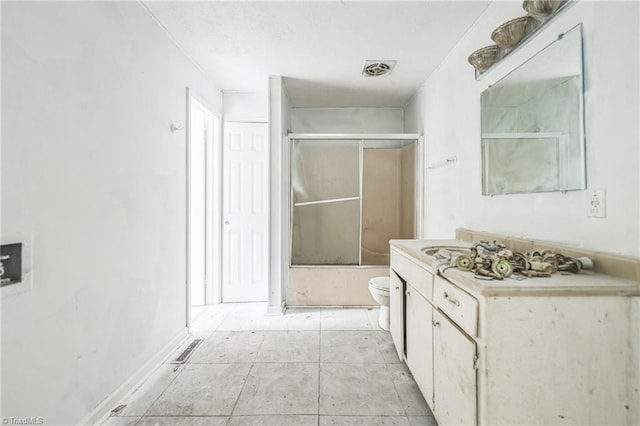 bathroom with vanity, toilet, bath / shower combo with glass door, and visible vents