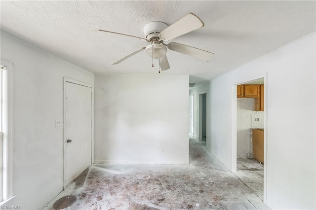 spare room featuring a textured ceiling and ceiling fan