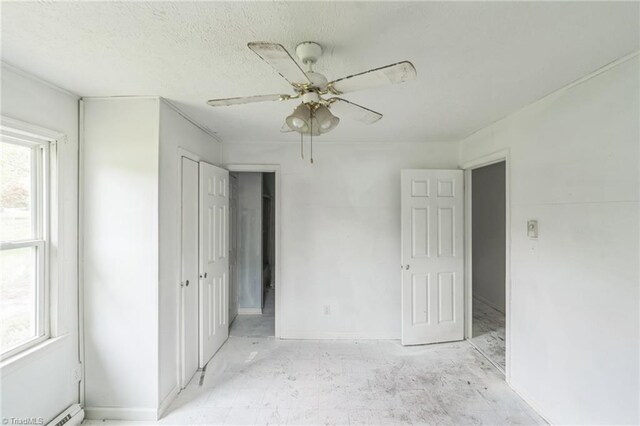 unfurnished bedroom with ceiling fan, baseboards, and a closet