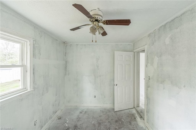 empty room with plenty of natural light and a ceiling fan