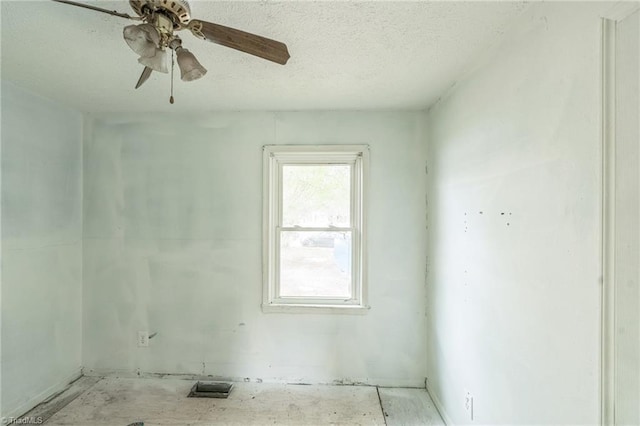 empty room featuring a textured ceiling, visible vents, and a ceiling fan