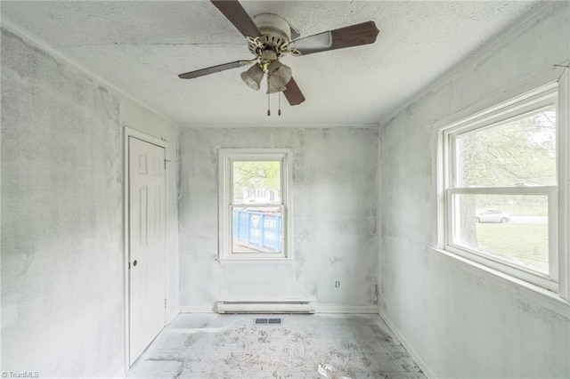 unfurnished room with a baseboard heating unit, baseboards, a textured ceiling, and ceiling fan