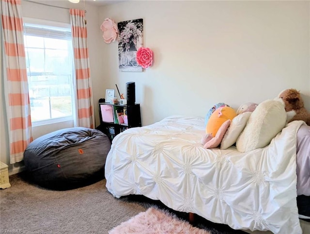 carpeted bedroom featuring multiple windows