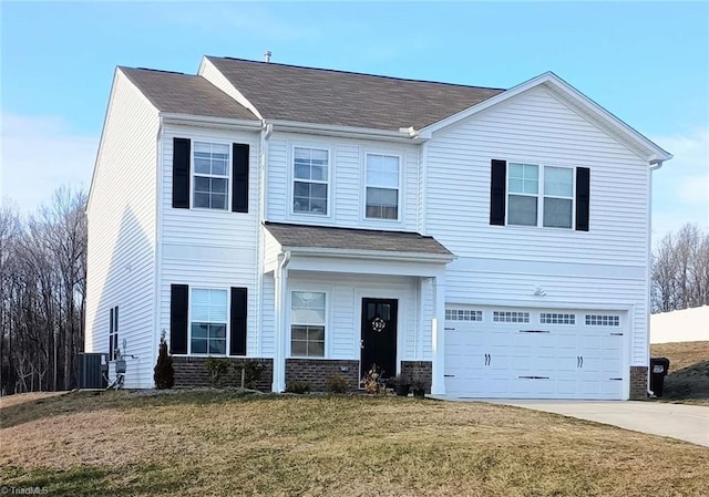 view of front facade featuring brick siding, a garage, driveway, and a front yard