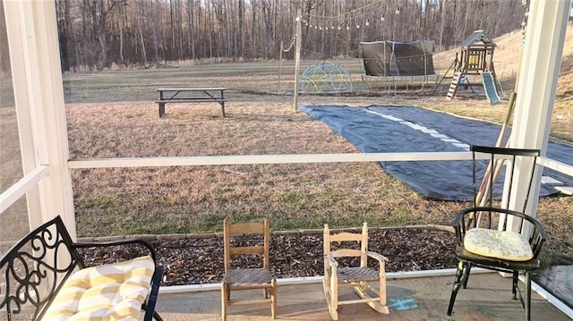 exterior space featuring a playground and a trampoline