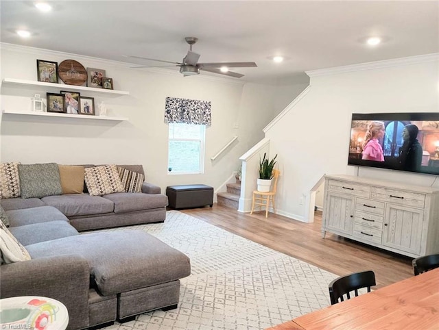 living area with light wood finished floors, stairway, and crown molding