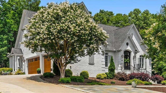 2550 Mountain Lake Rd, Asheboro, NC 27205 - view of front of property featuring driveway, a garage, roof with shingles, and brick siding