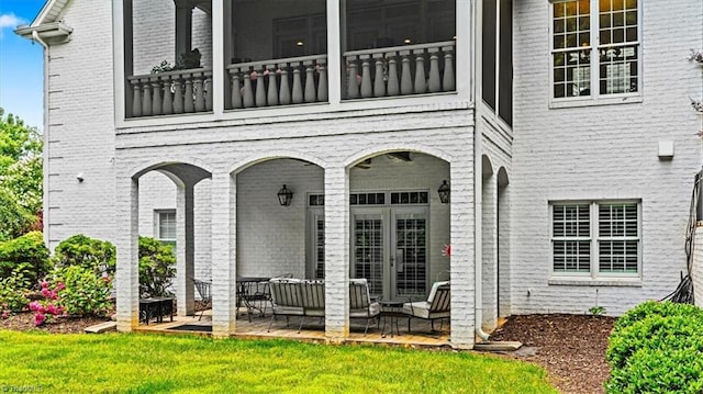 2550 Mountain Lake Rd, Asheboro, NC 27205 - property entrance featuring an outdoor living space, brick siding, a balcony, and a lawn