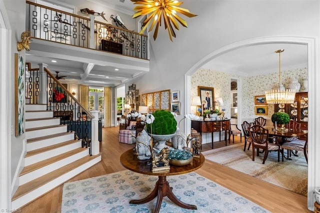 2550 Mountain Lake Rd, Asheboro, NC 27205 - entryway with wallpapered walls, a chandelier, wood finished floors, arched walkways, and ornamental molding
