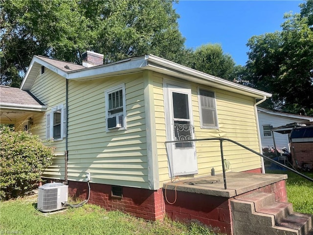 1107 Walnut St, Reidsville, NC 27320 - view of property exterior with crawl space, a chimney, and cooling unit