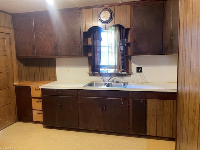 1107 Walnut St, Reidsville, NC 27320 - kitchen featuring light countertops, dark brown cabinetry, open shelves, and wooden walls