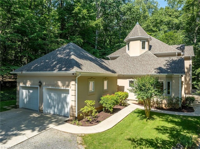 view of front of home with a garage and a front yard